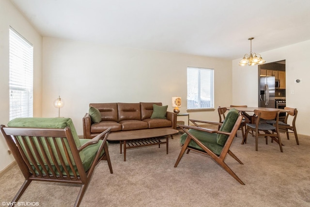 living room with an inviting chandelier and light colored carpet