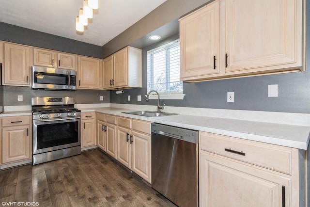 kitchen with dark wood-type flooring, stainless steel appliances, sink, and light brown cabinets