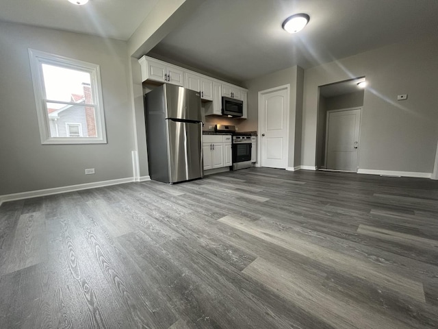 kitchen with stainless steel appliances, dark hardwood / wood-style floors, and white cabinets