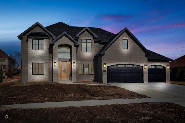 french country style house with a garage