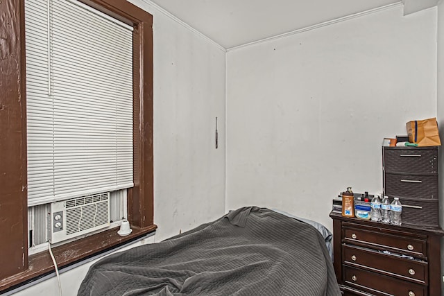 bedroom with cooling unit and crown molding