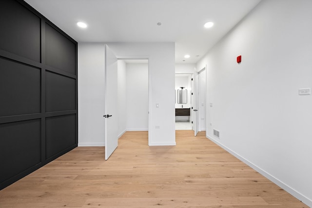 corridor featuring light hardwood / wood-style floors