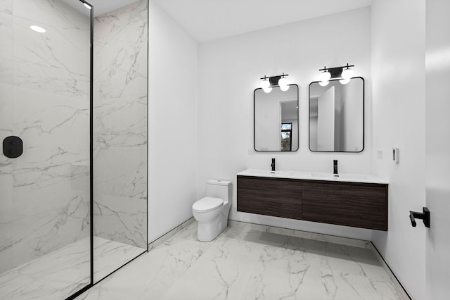 bathroom with vanity, tiled shower, and toilet