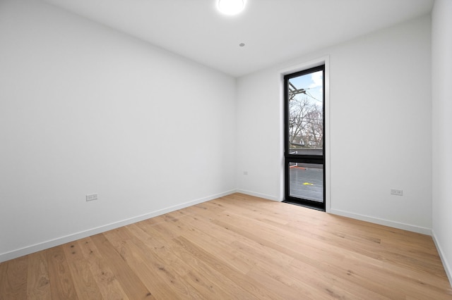 empty room with light hardwood / wood-style flooring