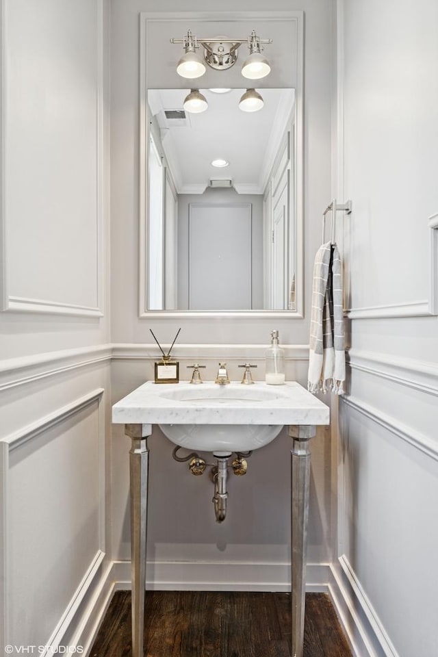 bathroom with a sink, wood finished floors, and visible vents