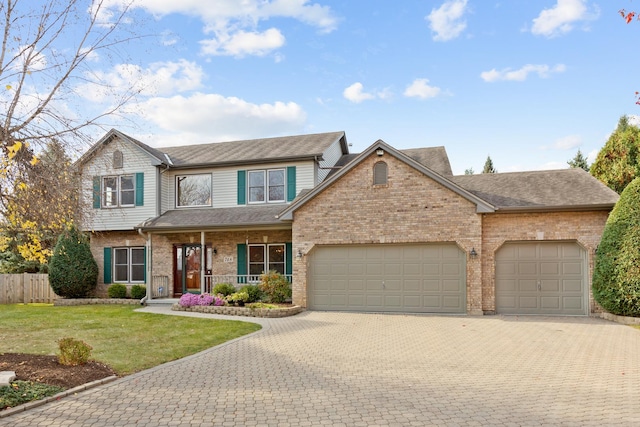 view of front facade with a porch, an attached garage, decorative driveway, a front lawn, and brick siding