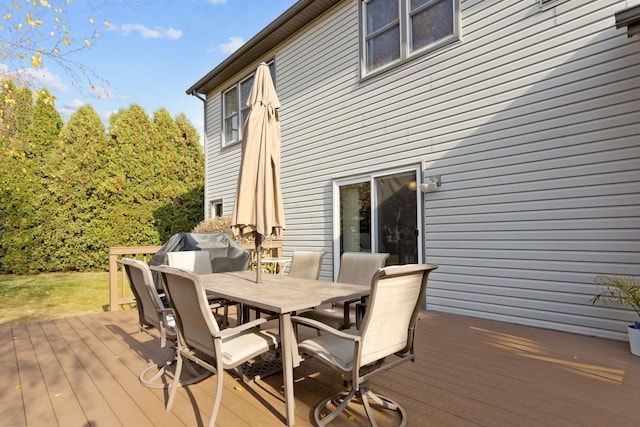 wooden deck featuring outdoor dining space