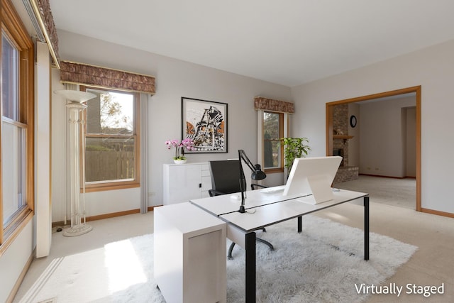 home office featuring light carpet, a brick fireplace, and baseboards