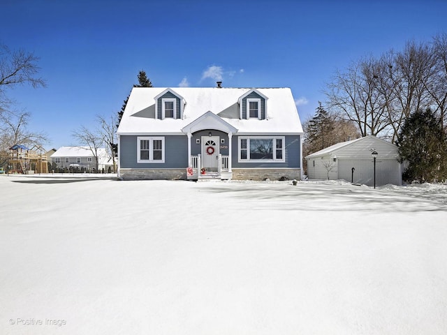 new england style home with a garage and an outbuilding