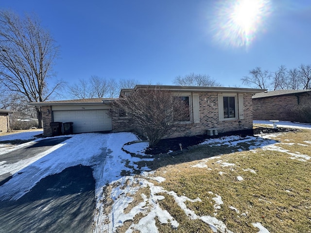 view of front of home with a garage and brick siding