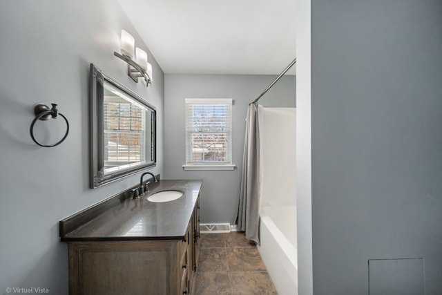 full bath featuring baseboards, visible vents, shower / bath combination with curtain, and vanity