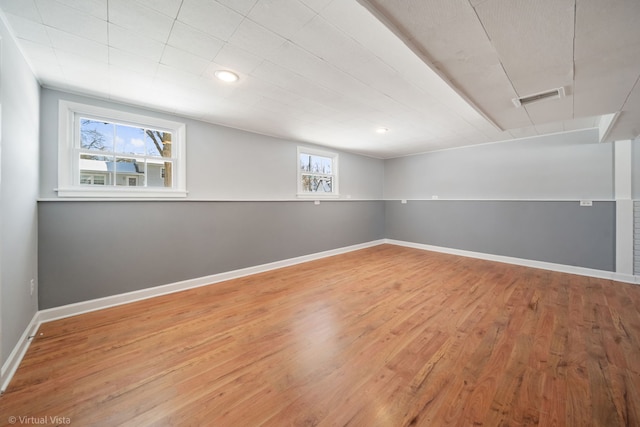 below grade area featuring visible vents, baseboards, wood finished floors, and recessed lighting