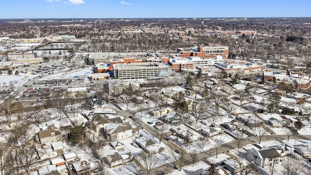 snowy aerial view with a city view