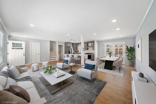 living room with light wood finished floors, ornamental molding, stairs, french doors, and recessed lighting