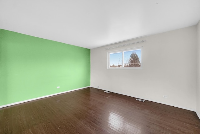 spare room with dark hardwood / wood-style floors