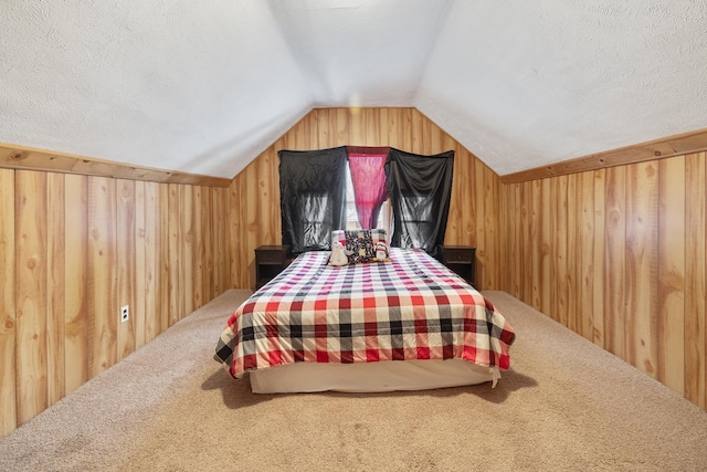 carpeted bedroom with lofted ceiling, wood walls, and a textured ceiling