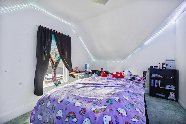 carpeted bedroom with vaulted ceiling and baseboards