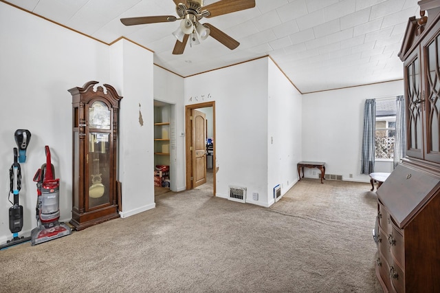 interior space featuring ornamental molding, visible vents, and carpet flooring