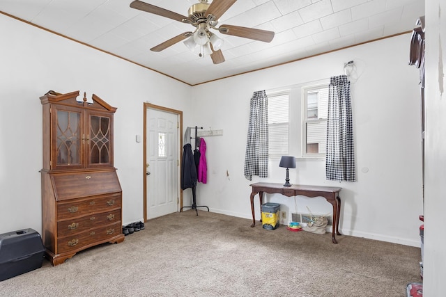 misc room featuring ornamental molding, carpet flooring, baseboards, and a ceiling fan