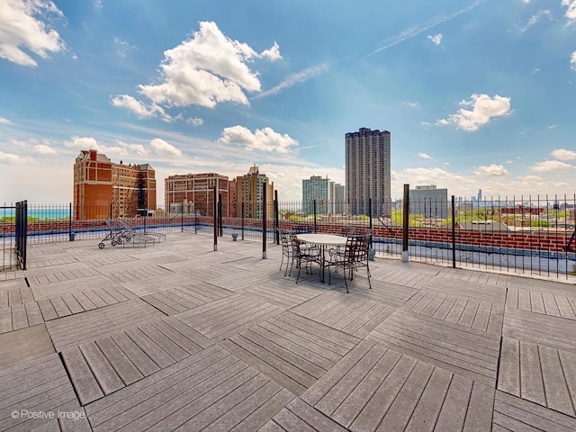 exterior space featuring fence and a city view