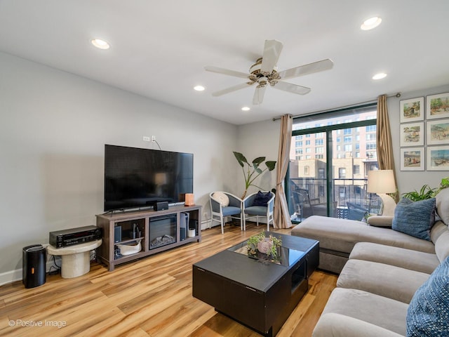 living area with recessed lighting, floor to ceiling windows, and wood finished floors