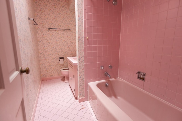 full bathroom with vanity, tiled shower / bath combo, tile patterned floors, and toilet