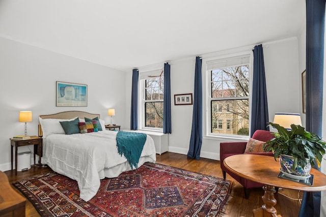 bedroom with wood finished floors and baseboards