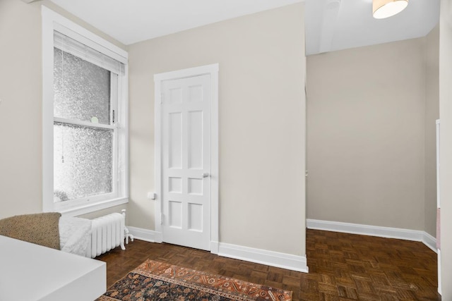 bedroom with radiator and baseboards