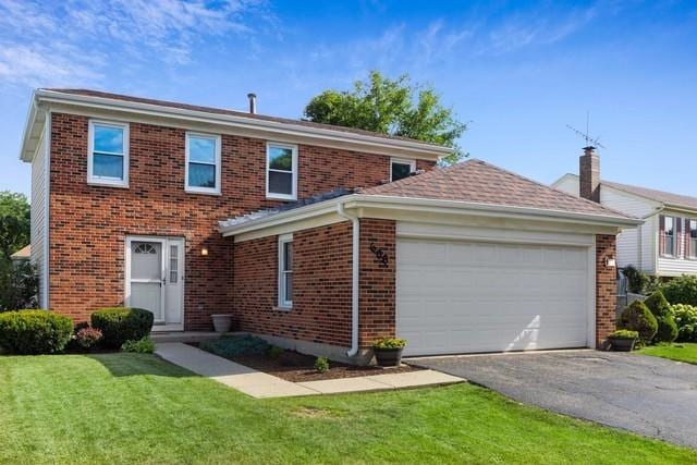 view of front facade with a garage and a front lawn