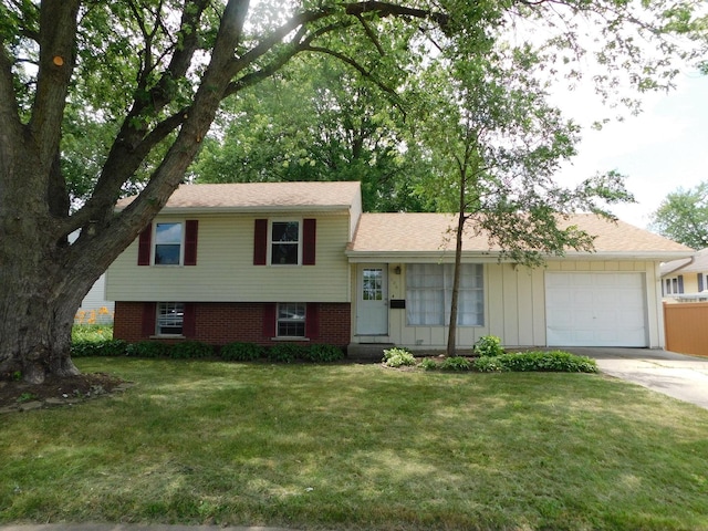 tri-level home featuring a garage and a front lawn