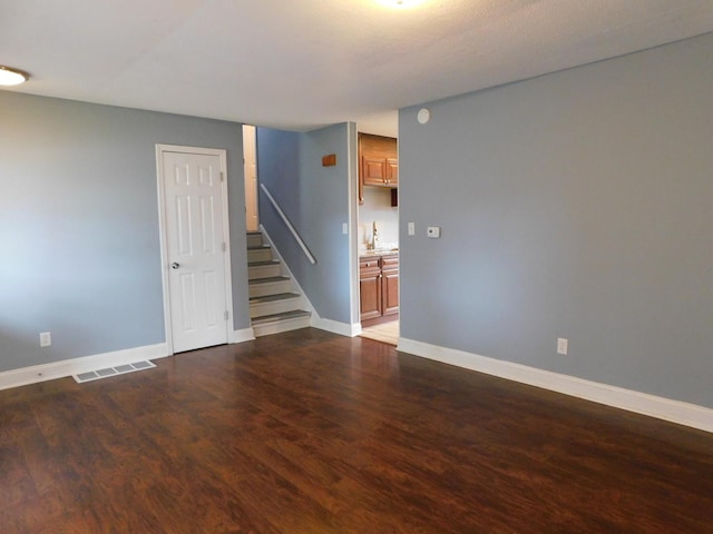 empty room with dark hardwood / wood-style floors