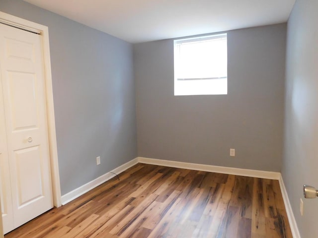 unfurnished room with hardwood / wood-style flooring