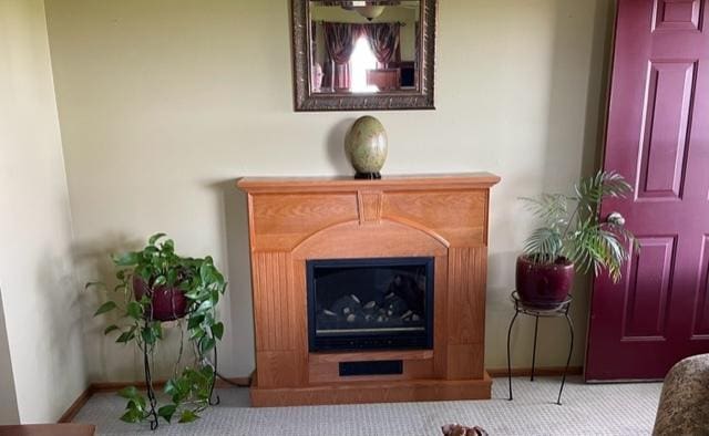 interior details with a fireplace, baseboards, and carpet flooring