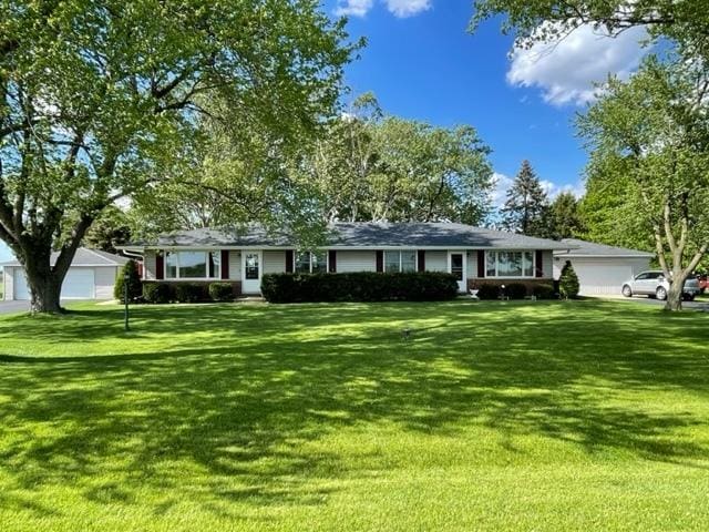 single story home featuring a garage and a front yard