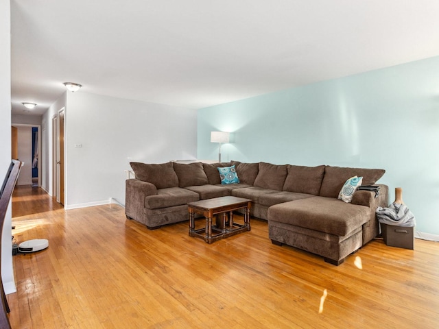 living area featuring baseboards and light wood-style floors