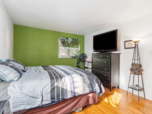 bedroom with light wood-style flooring and baseboards