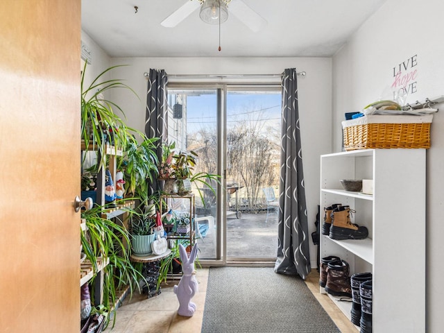 doorway with ceiling fan