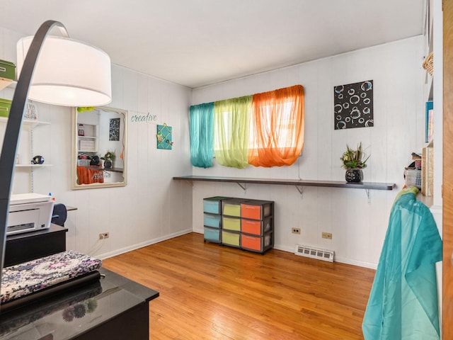 interior space with visible vents, baseboards, and wood finished floors