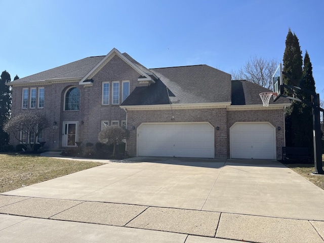 traditional-style house featuring a garage, driveway, brick siding, and a shingled roof