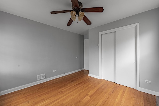 unfurnished bedroom with a closet, ceiling fan, and light hardwood / wood-style flooring