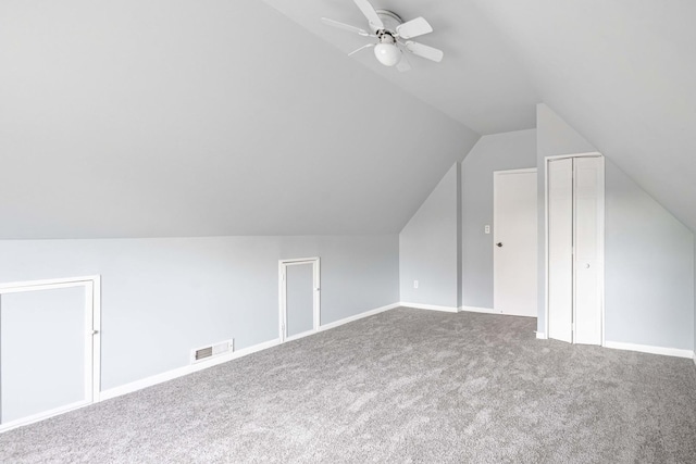 bonus room with ceiling fan, carpet flooring, and vaulted ceiling