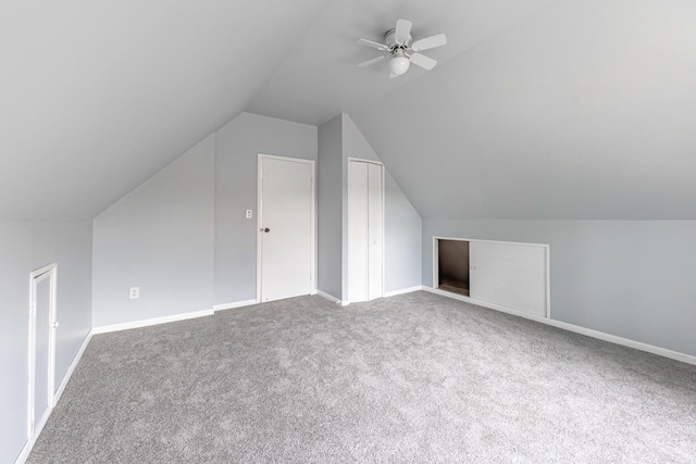 bonus room with vaulted ceiling, ceiling fan, and carpet flooring