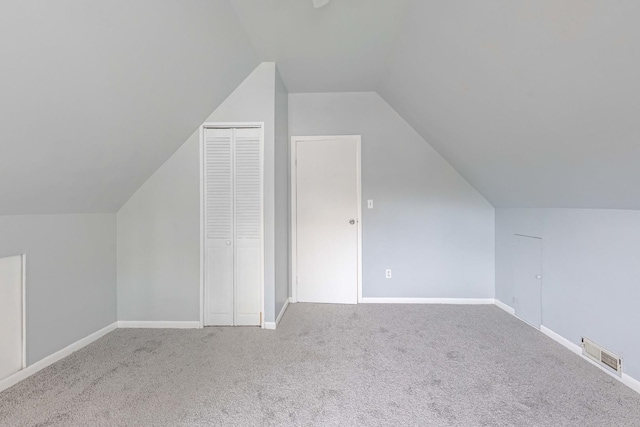 bonus room featuring lofted ceiling and carpet flooring