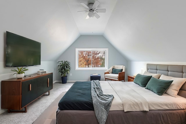 bedroom with vaulted ceiling, light colored carpet, and ceiling fan