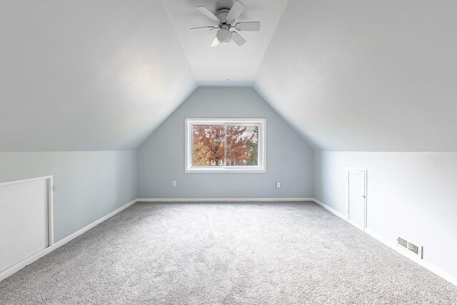 additional living space with lofted ceiling, carpet floors, and ceiling fan