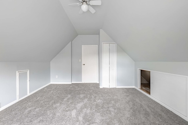 additional living space featuring vaulted ceiling, ceiling fan, and carpet floors