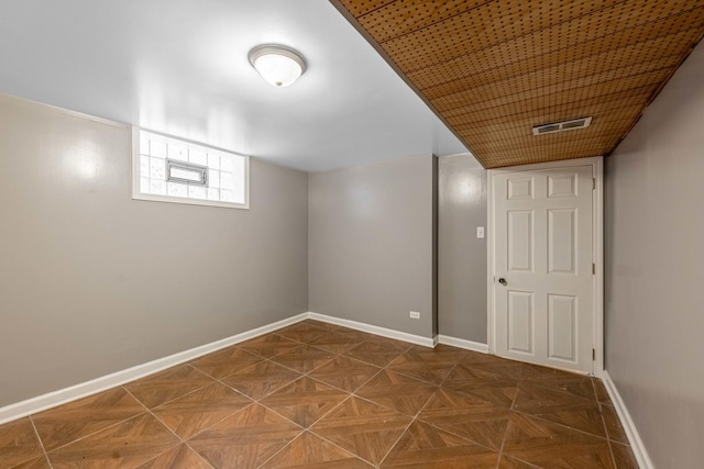 basement with dark parquet flooring