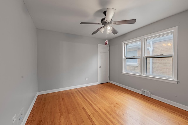 spare room with ceiling fan and light wood-type flooring