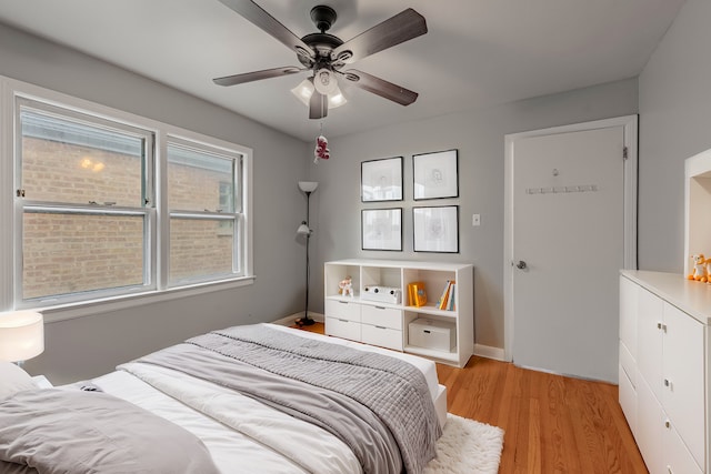 bedroom with ceiling fan and light hardwood / wood-style flooring