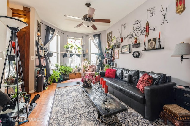 living room featuring a ceiling fan and hardwood / wood-style floors